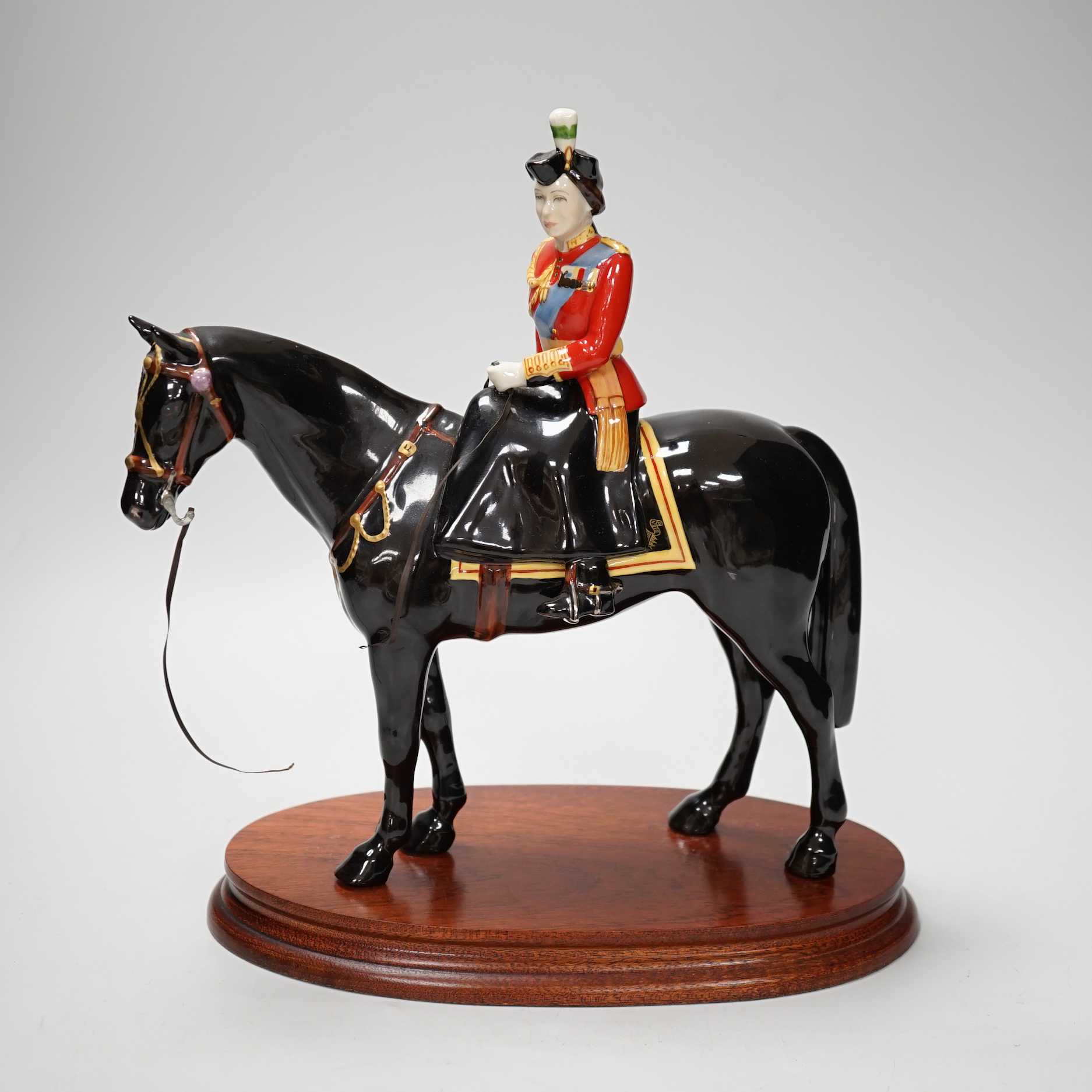 A Beswick ‘trooping the colour’ limited edition figure of Her Majesty The Queen on Burmese, on stand. 151/500
